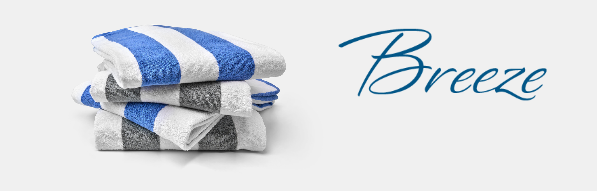 Stack of striped towels with 'Breeze' branding on a light background