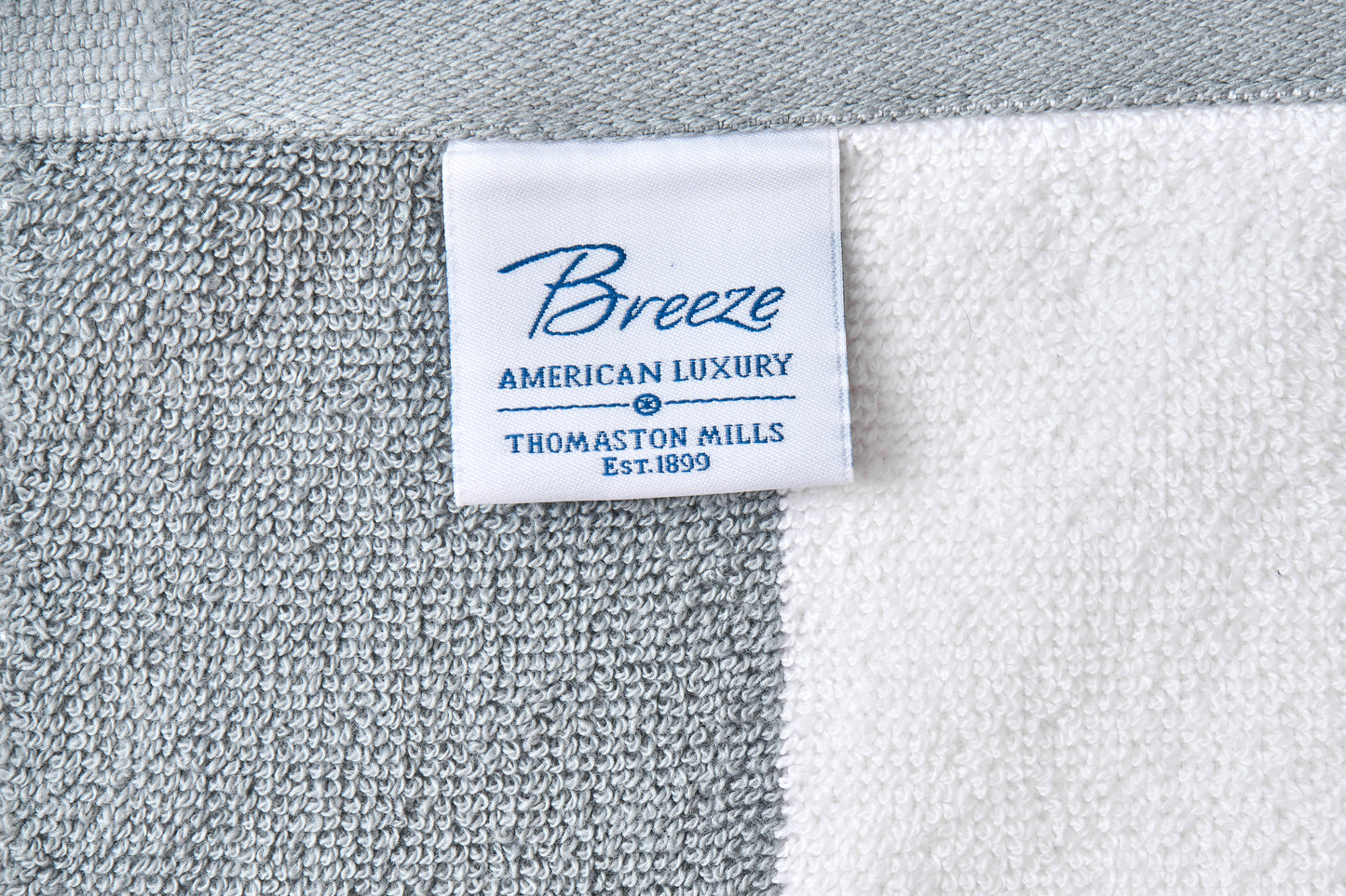 Close-up of a 'Breeze' label on a textured fabric background