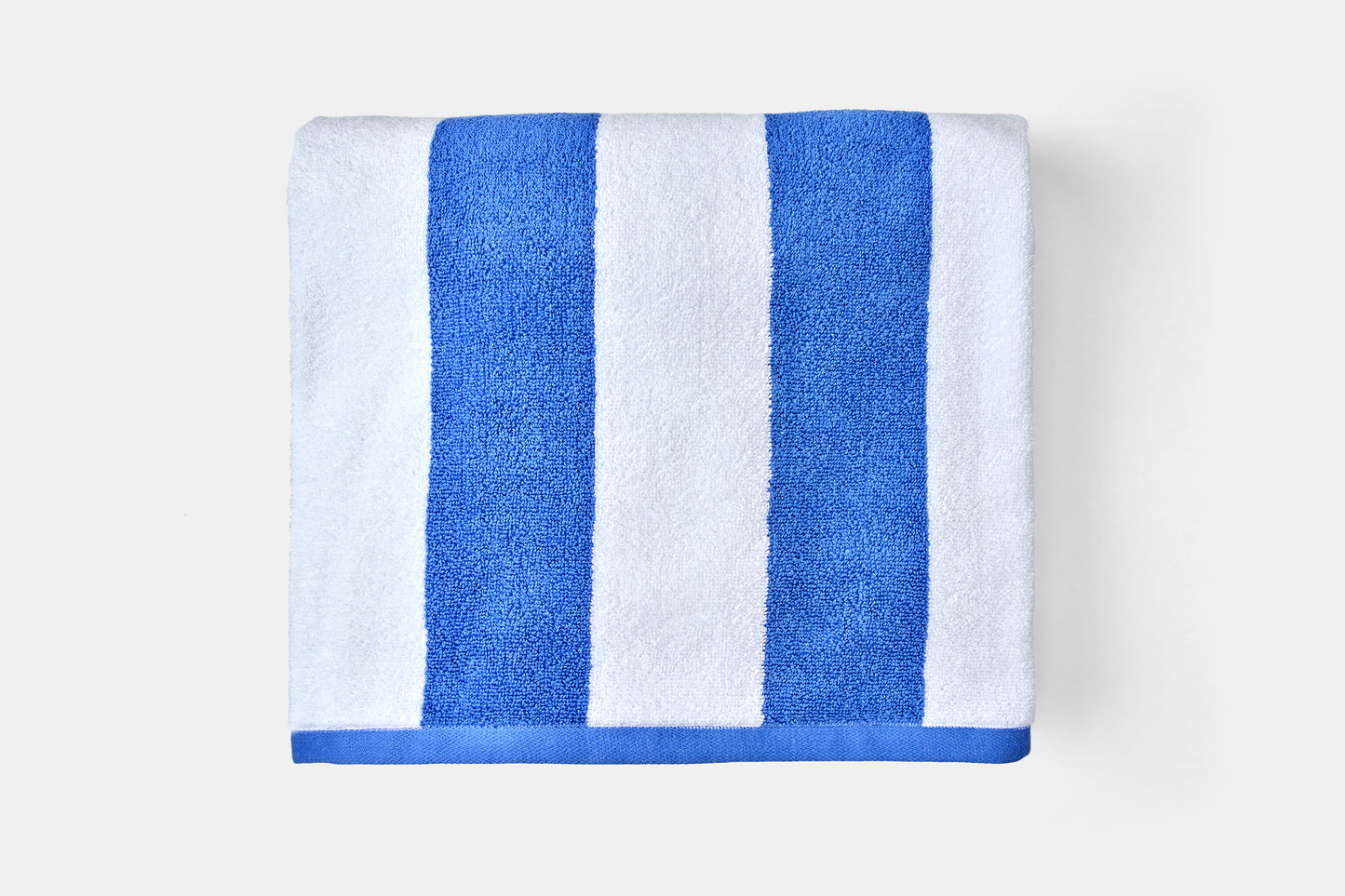 Towel with blue and white stripes on a light gray background