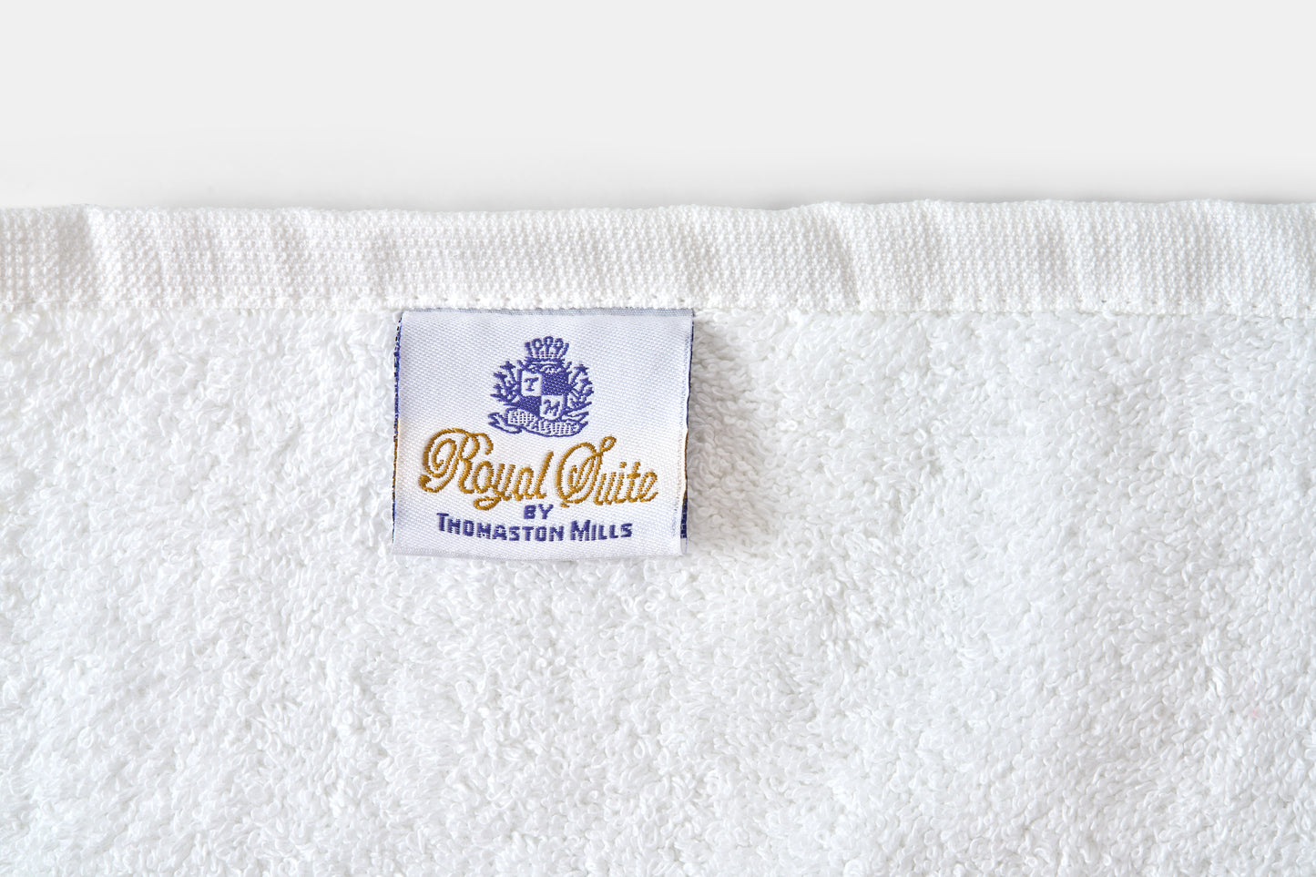 White towel with 'Royal Suite' label on a white background