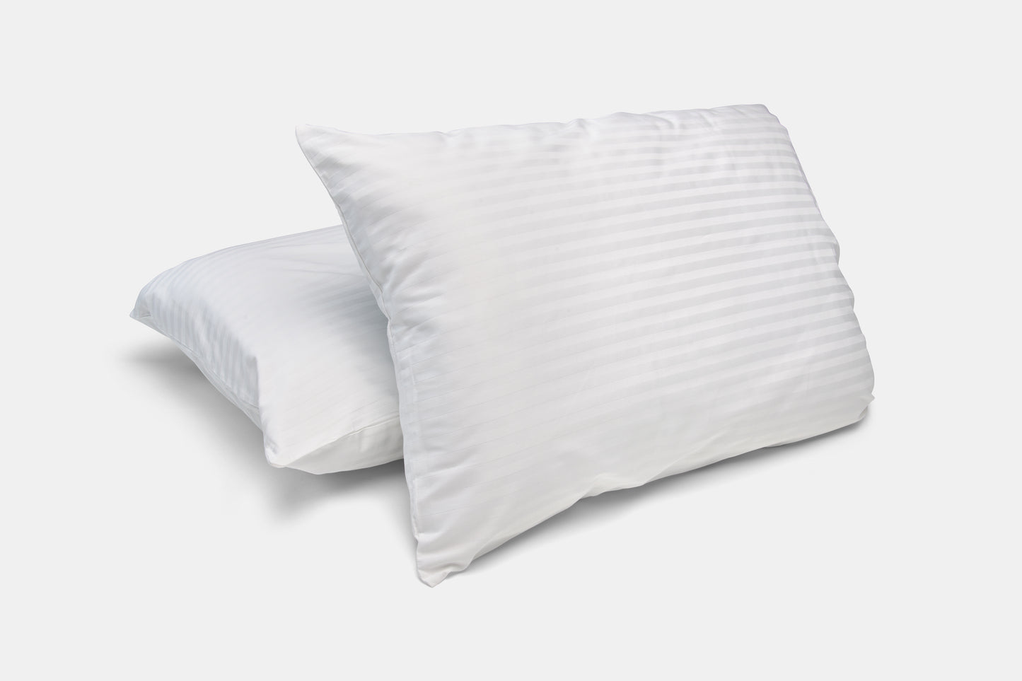Two white pillows on a light gray background