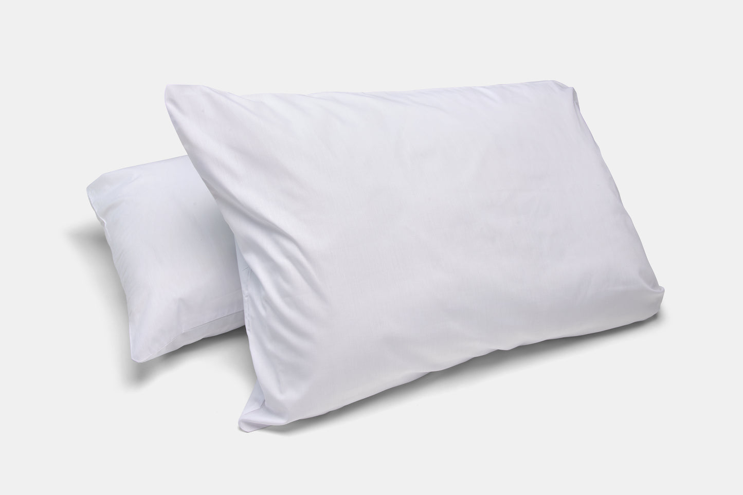 Two white pillows on a light gray background