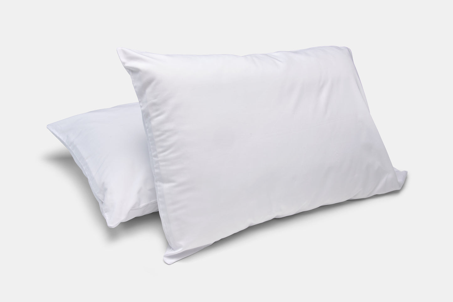 Two white pillows on a light gray background