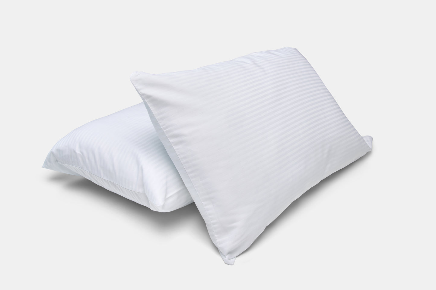 Two white pillows on a light gray background