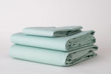 Thomaston Mills Pastel Seafoam Green sheets folded and stacked.