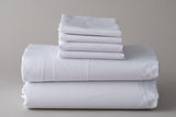 Thomaston T-200 Pillowcases and sheets folded and stacked.