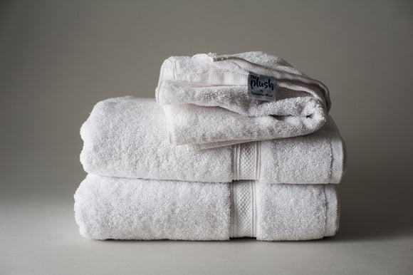 White TM Plush by Thomaston Mills towels folded and stacked.