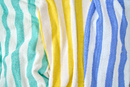 Stack of colorful striped towels in turquoise, yellow, and blue.