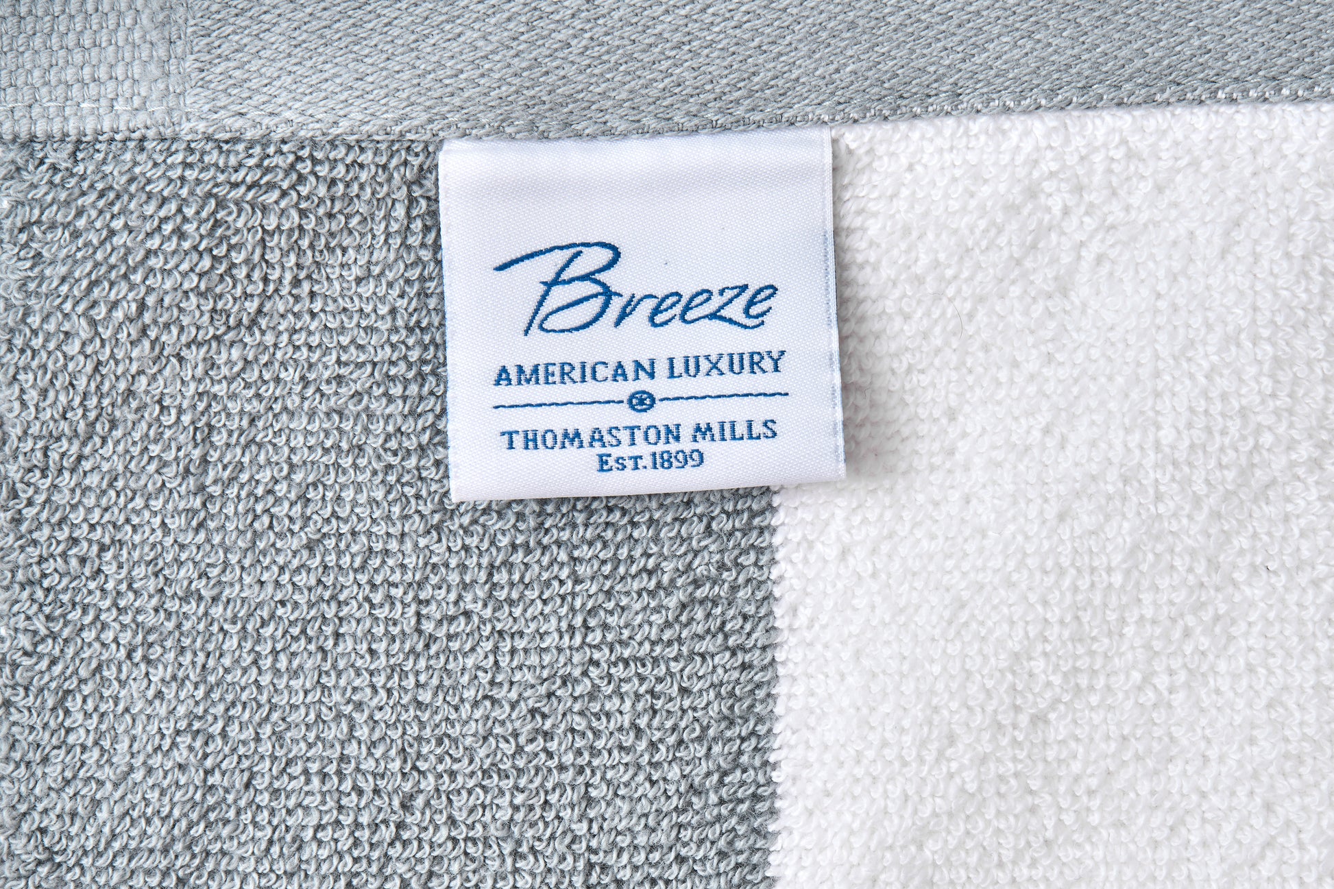 Close-up of a 'Breeze' label on a textured fabric background