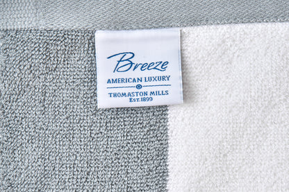 Close-up of a 'Breeze' label on a textured fabric background