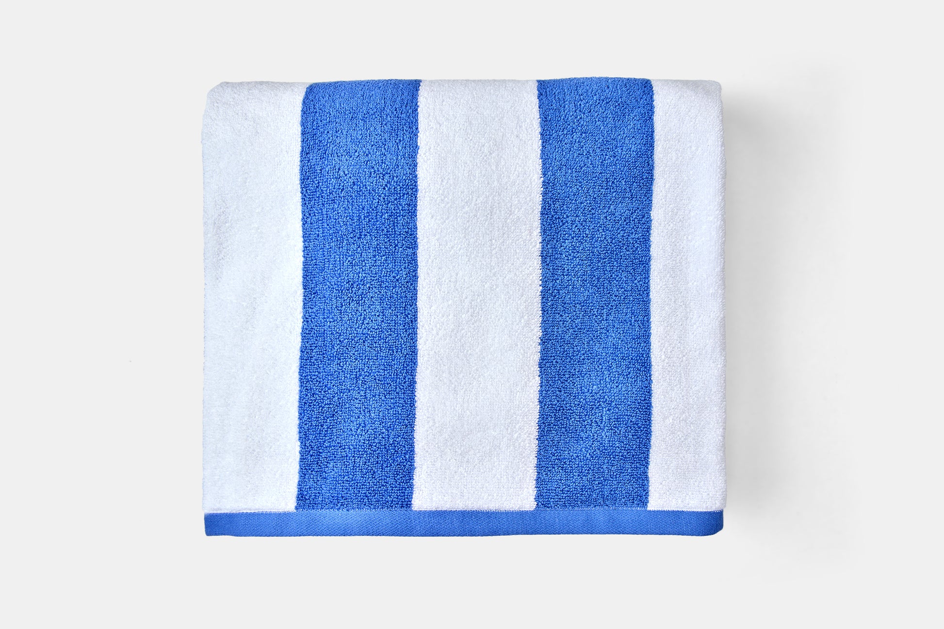 Towel with blue and white stripes on a light gray background