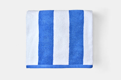 Towel with blue and white stripes on a light gray background