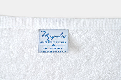 Label on a white fabric with 'Magnolia American Luxury' text