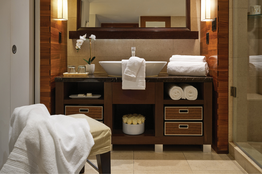 Bathroom with wooden vanity, sink, and towels