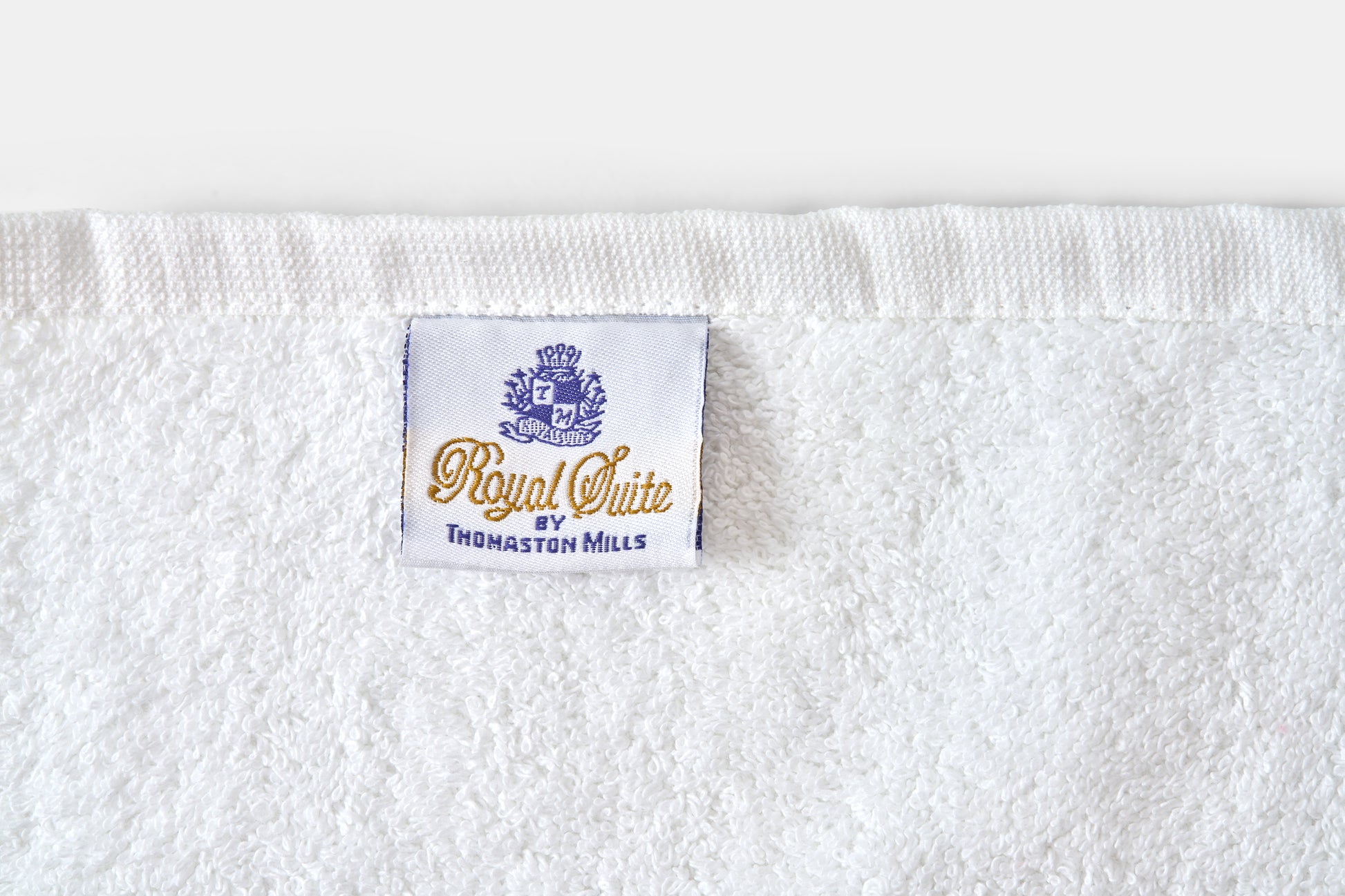 White towel with 'Royal Suite' label on a white background