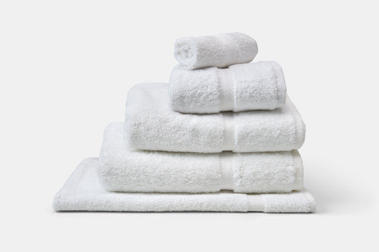 Stack of white towels on a white background