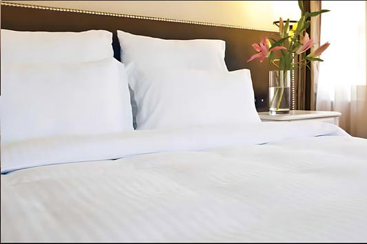 Hotel Bed Sheet white Twill T250 CottonPoly Satin Stripe on a bed