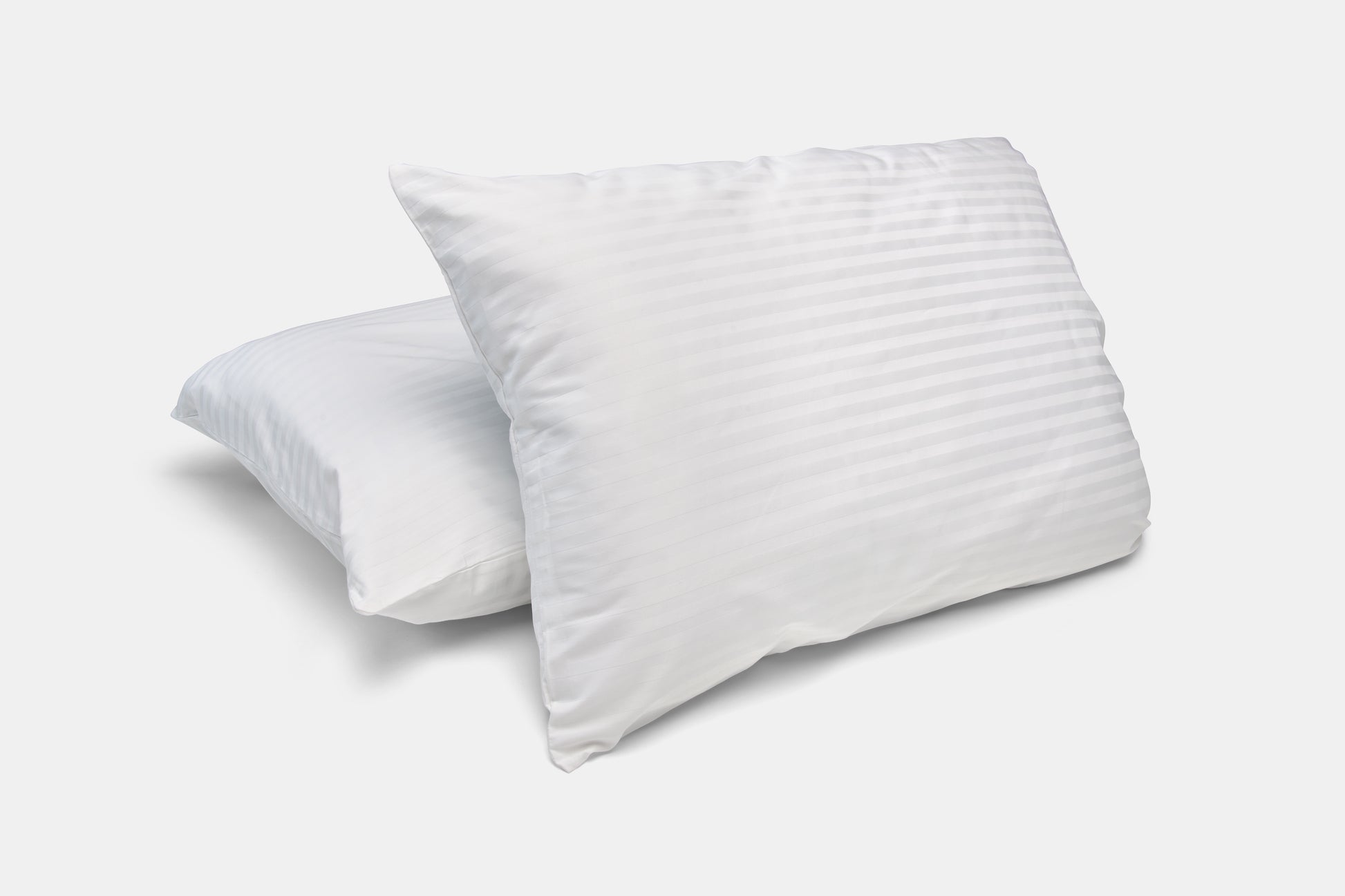 Two white pillows on a light gray background