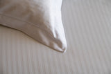 The corner of a Thomaston Mills pillow sham on top of a Thomaston Mills Duvet cover