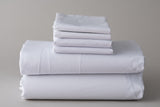 White Thomaston Healthcare Sheets and Pillowcases folded and stacked.