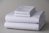 Thomaston Mills T-250 Satin Stripe Sheets and Pillowcases folded and stacked.