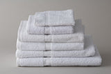 White Thomaston Healthcare towels folded and stacked.