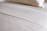 Close up image of a bed made with Thomaston Mills Decorative Top Sheet.